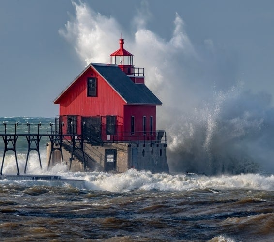 Waves crashing onto second Grand Haven lighthouse